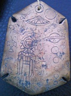 an old metal tag with some drawings on it