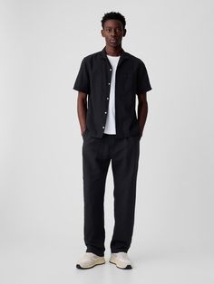 Soft linen-cotton pleated trousers.  Concealed hook and bar closure, zip fly.  Front slant pockets, back welt pockets.  Fit: Classic.  An easy silhouette that fits close at the waist, and is relaxed through the hips and thigh.  Models are 6′1″–6′2″ 185 cm–188 cm) with a 31″ 79 cm) waist & 32–33″ 81 cm–84 cm) inseam & are wearing Gap Cropped Mens Dress Pants, Mens Cropped Black Pants, Mens Black Pants, Workwear Men, Black Workwear, Easy Silhouette, Black Pants Men, Mens Workwear, Black Slacks