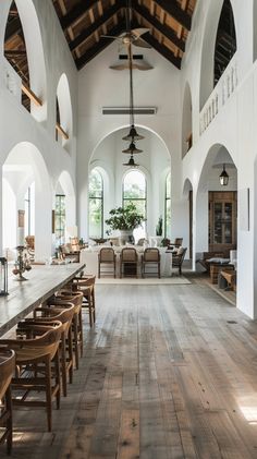 a large room with wooden floors and vaulted ceilings