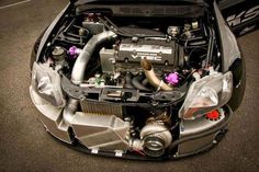 the engine compartment of a sports car with its hood open