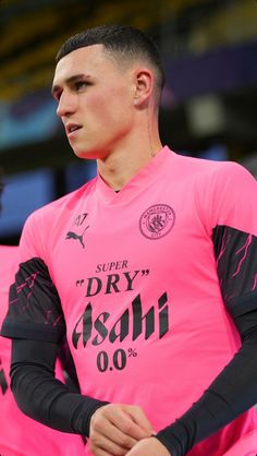 a man in pink jersey standing next to another person wearing black gloves and holding a basketball