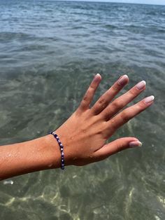 This bracelet is inspired by Greece and the color scheme of the architecture in islands like Santorini and Mykonos. It also reminds me of the movie 'Mamma Mia' which is one of my favorite movies of all time. This jewelry piece is made with many different beads like pearls, 3 different kinds of blue beads, a small striped blue bead and a variety of silver beads. Spiritual Bangle Friendship Bracelets For Beach, Spiritual Friendship Bangle Bracelets For Beach, Mamma Mia Jewelry, Greece Bracelet, Greece Jewelry, Beads Design, Movies Of All Time, Kind Of Blue, Pearl Shell