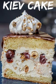 a close up of a piece of cake on a plate with whipped cream and nuts