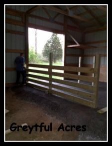 a man standing in the doorway of a barn