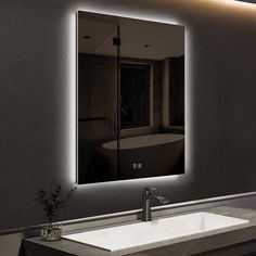 a bathroom sink under a large mirror with lights on it