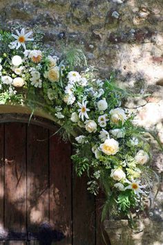 a doorway with flowers and greenery on it