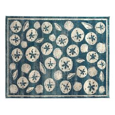 a blue rug with shells and leaves on it