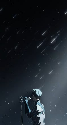 a man standing on top of a snow covered slope under a sky filled with stars