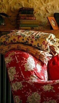 a heart shaped pillow sitting on top of a red chair