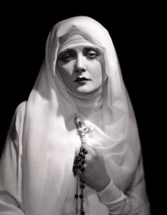 black and white photograph of a woman wearing a veil