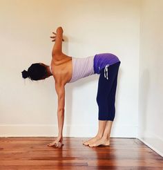 a woman standing on one leg in a yoga position