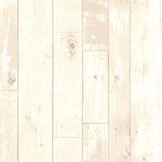 a white wooden floor with peeling paint on the walls and wood planks in it