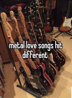 some guitars are lined up in a room with the words metal love songs hit different