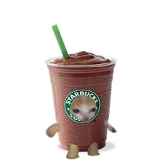 a starbucks drink with a green straw sticking out of it's face and legs