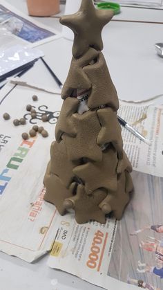 a clay christmas tree sitting on top of a table