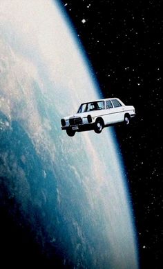 a car flying over the earth in space