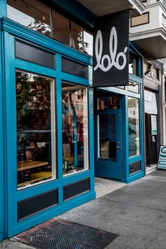 a blue store front on the side of a street