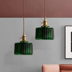 two green lamps hanging from the ceiling in a room