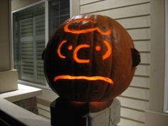 a carved pumpkin sitting on top of a porch