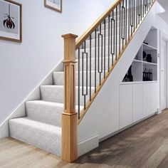 there is a stair case next to the banister in this house with white walls and wood floors