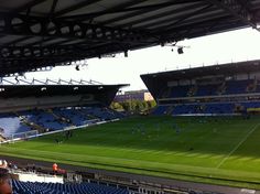 an empty soccer stadium with blue seats