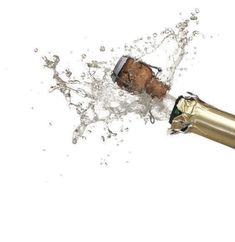 an open champagne bottle with water splashing out of it and the corks still attached