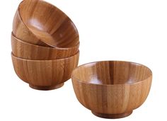 three wooden bowls sitting next to each other