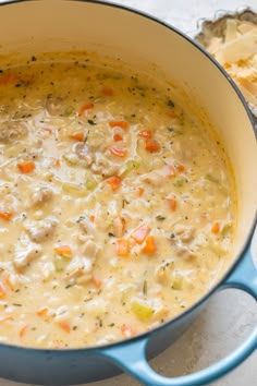 a blue pot filled with soup on top of a table