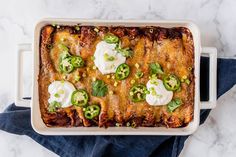 an enchilada casserole with sour cream and jalapenos