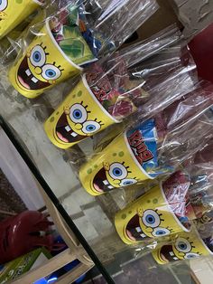 the spongebob cups are lined up on the shelf in the store for sale