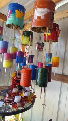 many different colored paper cups hanging from the ceiling