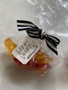 two bags filled with jelly bears sitting on top of a table