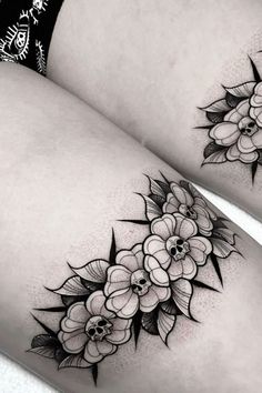 two women's thigh tattoos with flowers on the thighs and one is black and white