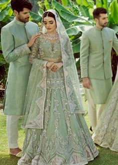 the bride and groom are dressed in green outfits