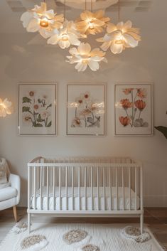 a baby's room with white furniture and paintings on the wall, including a crib