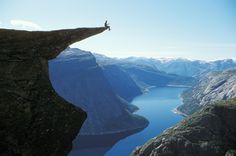 a person standing on the edge of a cliff with a quote above it that says, let