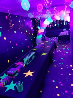 a party room with balloons, streamers and confetti on the floor at night