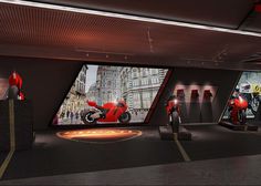 an exhibit with red motorcycles and people in the background