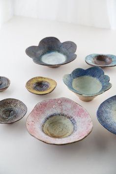 several bowls are arranged on a white surface