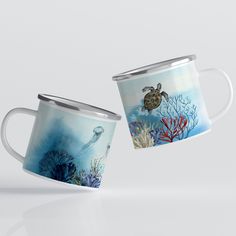 two coffee mugs with sea animals and corals on them, one has a turtle in the ocean