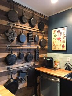 a kitchen with pots and pans hanging on the wall