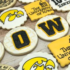 decorated cookies with black and yellow letters on them