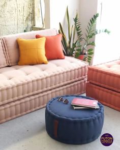 a living room with two couches and a round footstool in the middle