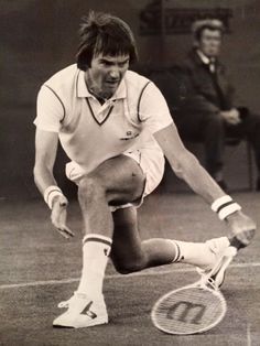 an old photo of a tennis player crouching down