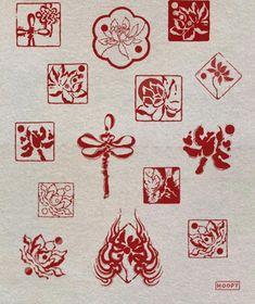 a bunch of red and white designs on a piece of paper that is sitting on a table