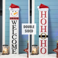 two snowmen standing next to each other in front of a sign that says welcome