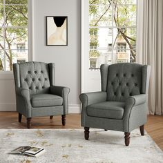 two gray chairs sitting next to each other on top of a white carpeted floor