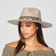 Beige rancher hat with a leather band. The leather band has turquoise color accents. Womens Western Fashion