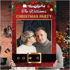 a man and woman standing next to each other in front of a christmas photo frame