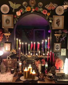 a table topped with lots of candles and pictures